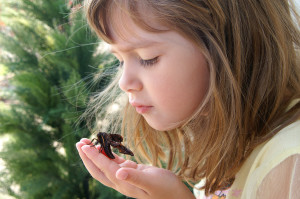 Young girl mindfully looking at a moth