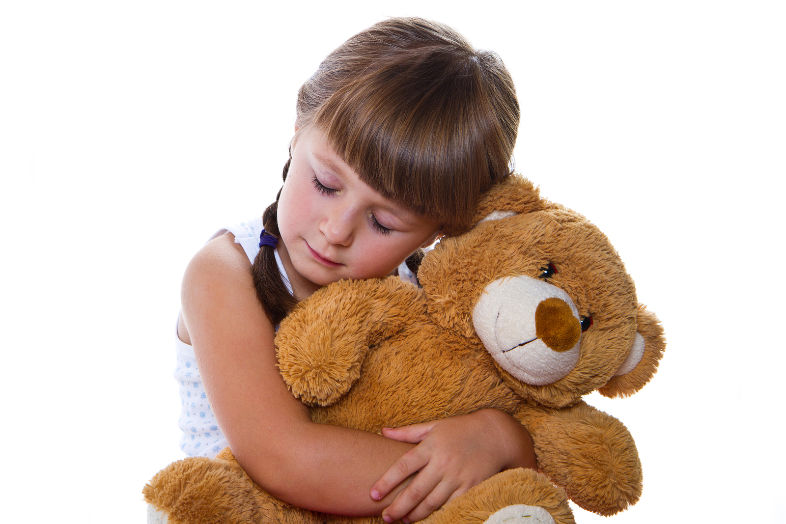girl hugging teddy bear